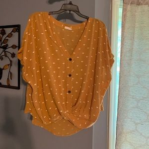 Women mustard color blouse with white diamonds figures all around